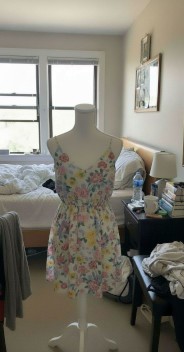 Amateur cell phone shot of floral dress on mannequin