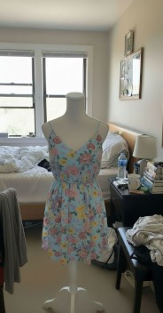 Amateur cell phone shot of blue floral dress on mannequin